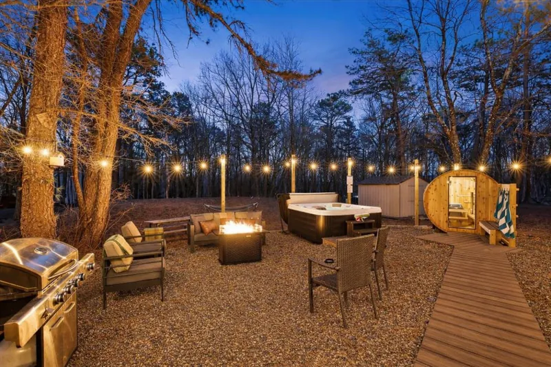 String lights overhead, steam rising from the hot tub, cedar sauna glowing in the dark. Your evenings just got a whole lot better