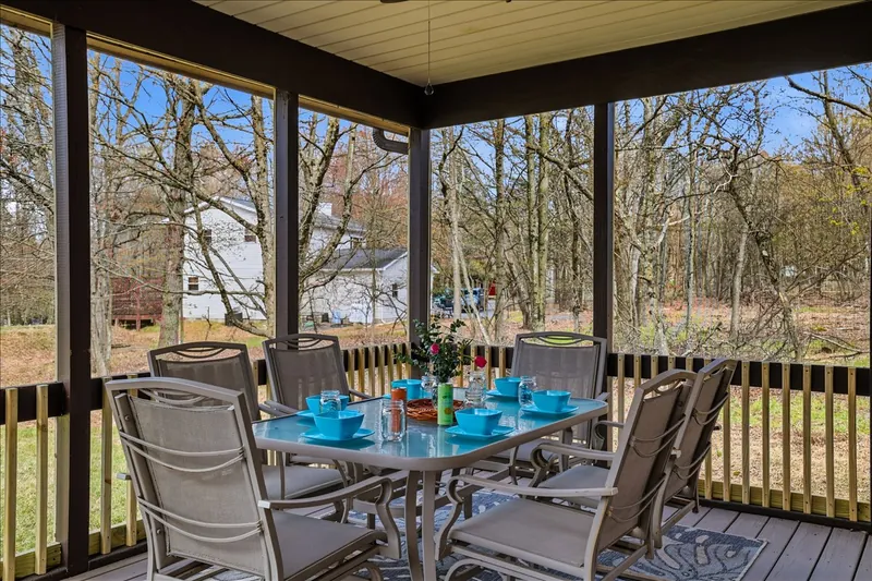 The screened-in porch was made for slow mornings and cozy evenings. Hammock naps, outdoor dining and fresh Pocono air included