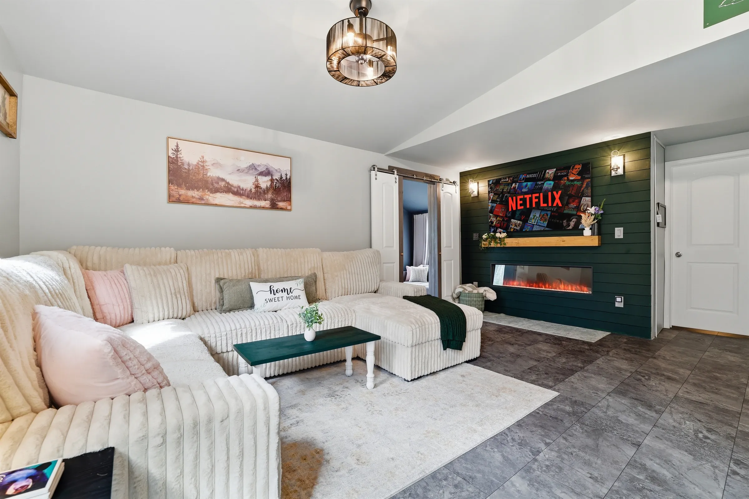 The perfect combination: A cozy sofa, a smart TV, and the fireplace crackling away. 