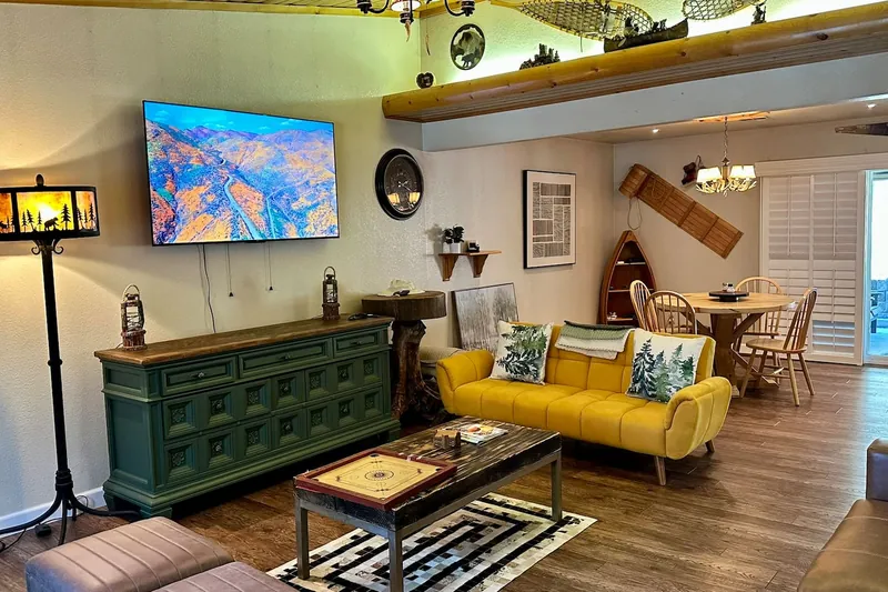 An ample living room with a TV and board games like chess!