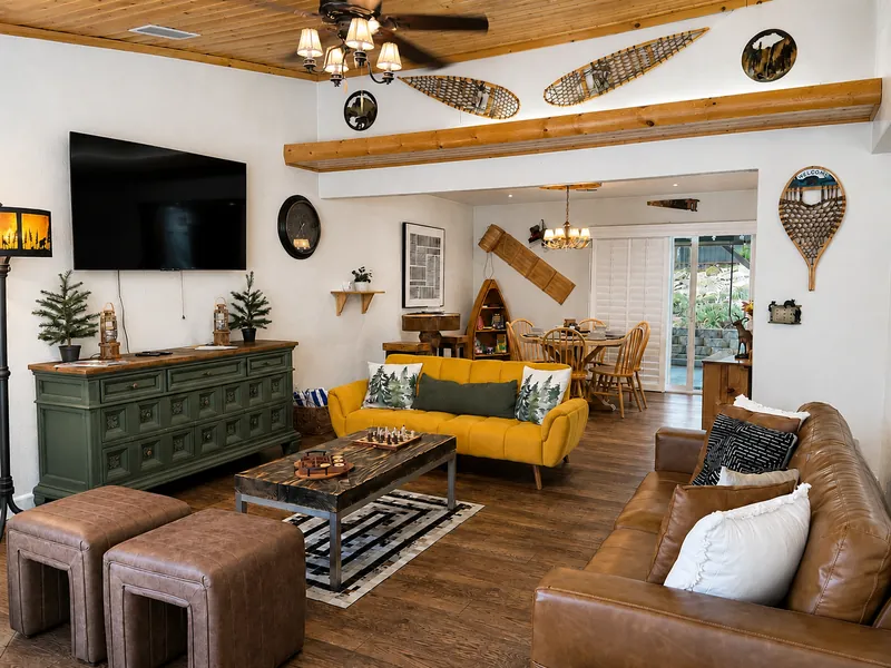 An ample living room with a TV and board games like chess!